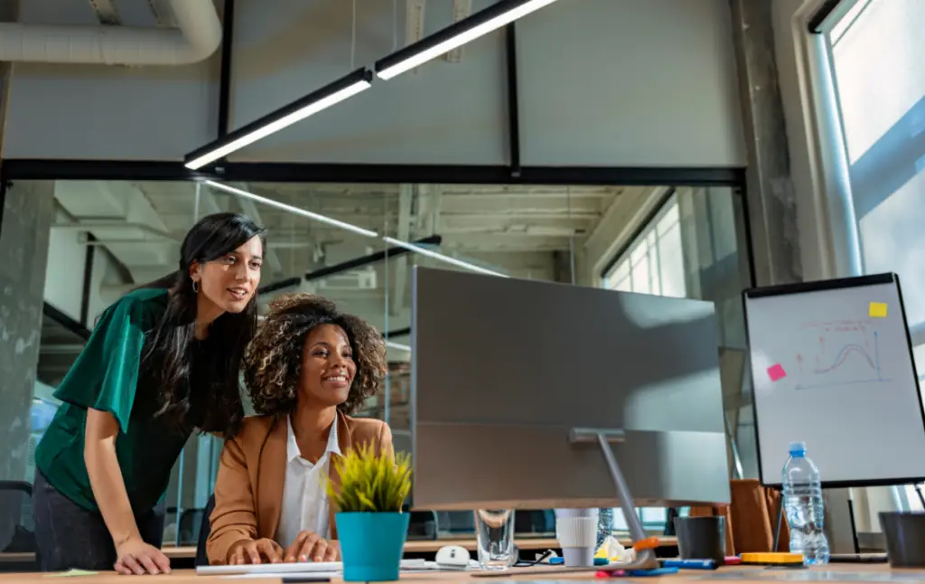 Un formateur offre un accompagnement personnalisé à un stagiaire sur ordinateur.